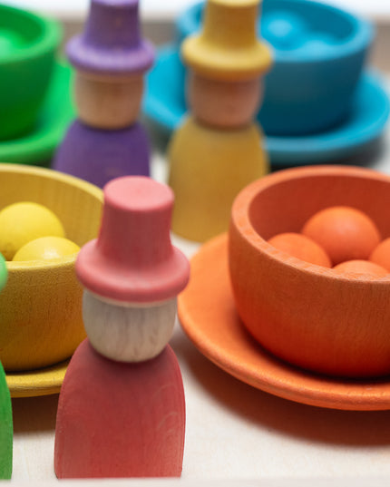 Wooden toys - Colored dolls, bowls and balls on a tray