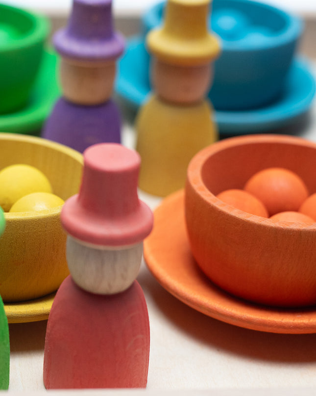 Wooden toys - Colored dolls, bowls and balls on a tray