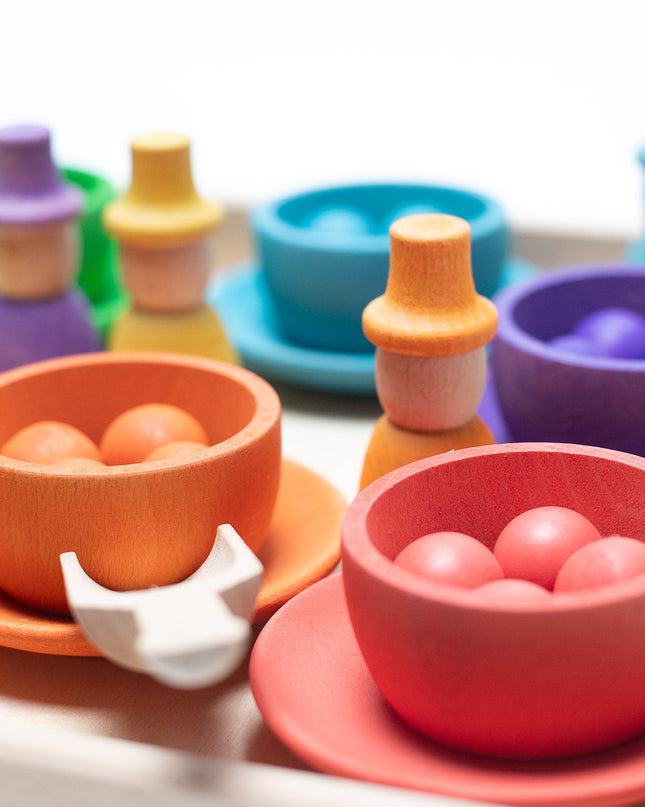 Wooden toys - Colored dolls, bowls and balls on a tray