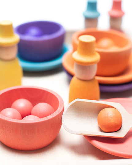 Wooden toys - Colored dolls, bowls and balls on a tray