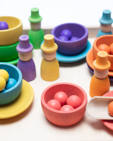 Wooden toys - Colored dolls, bowls and balls on a tray