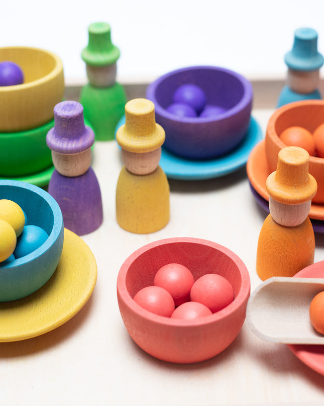 Wooden toys - Colored dolls, bowls and balls on a tray