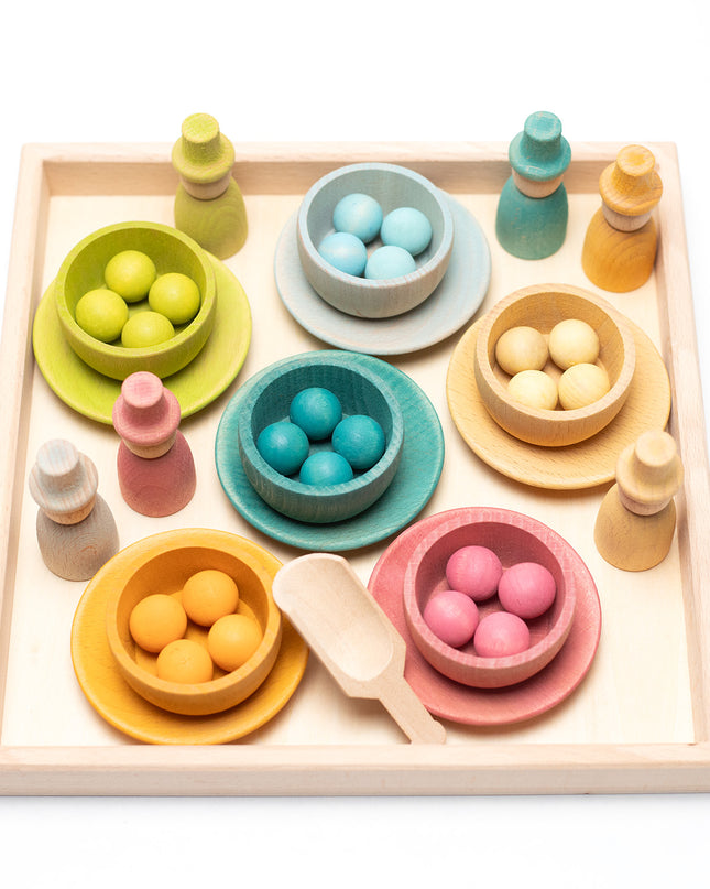 Wooden toys - Colored dolls, bowls and balls on a tray